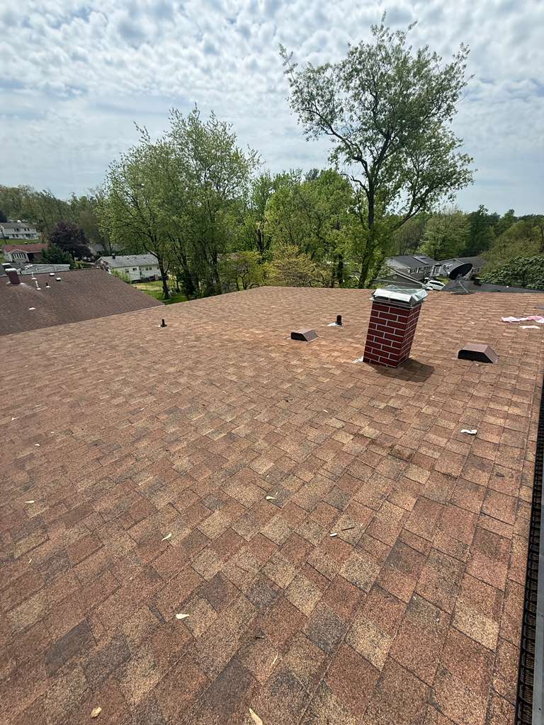 Roofer installing shingles